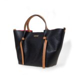 Handcrafted in Italy from the finest genuine pebbled Italian leather, this exquisite bag exudes refinement and modern grace. The exclusive Noir Tan colorway – a midnight-black exterior accented by rich tan handles and trim – creates a striking two-tone contrast that is both classic and fashion-forward.